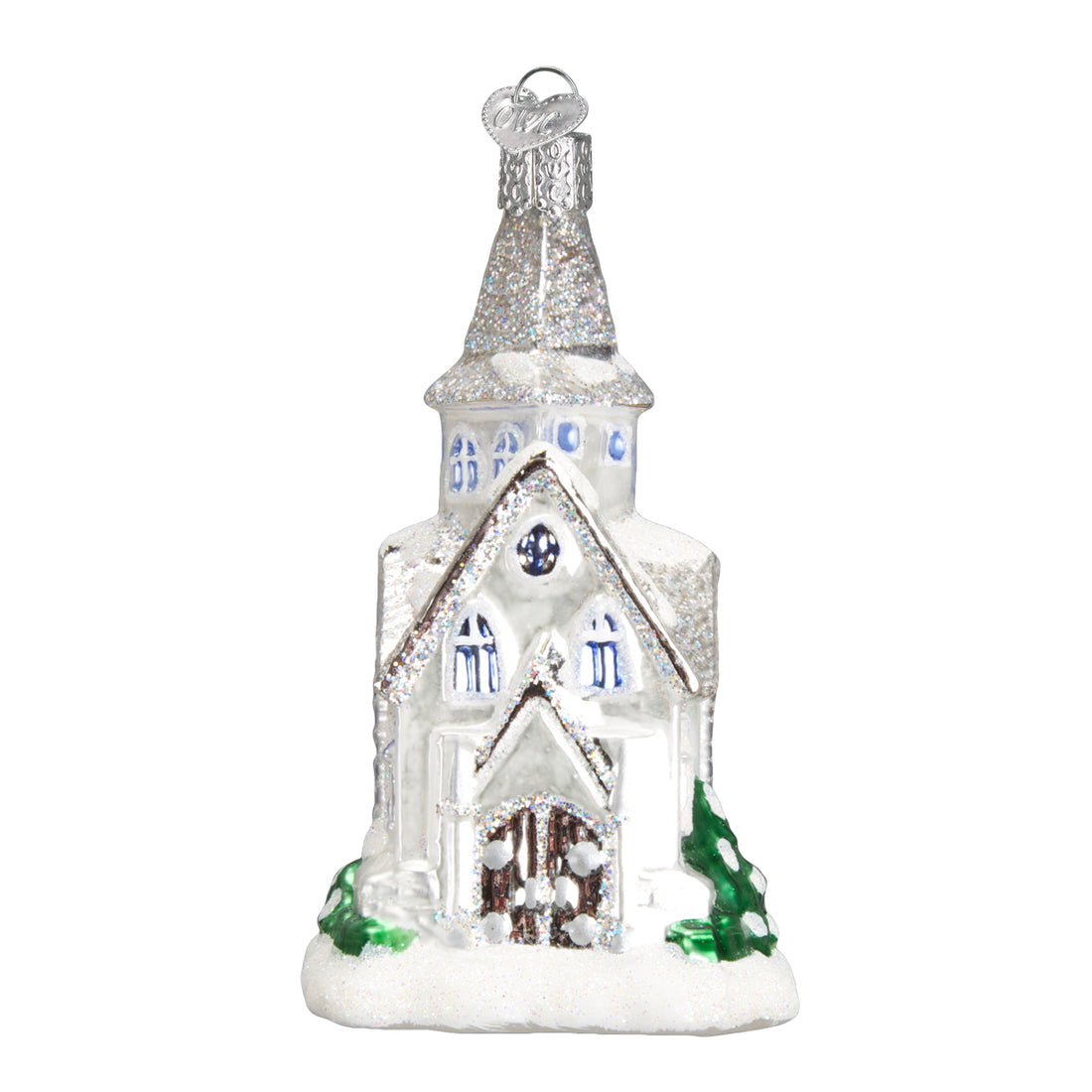 Sparkling white glass cathedral ornament with silver glitter accents and green trees at the base.