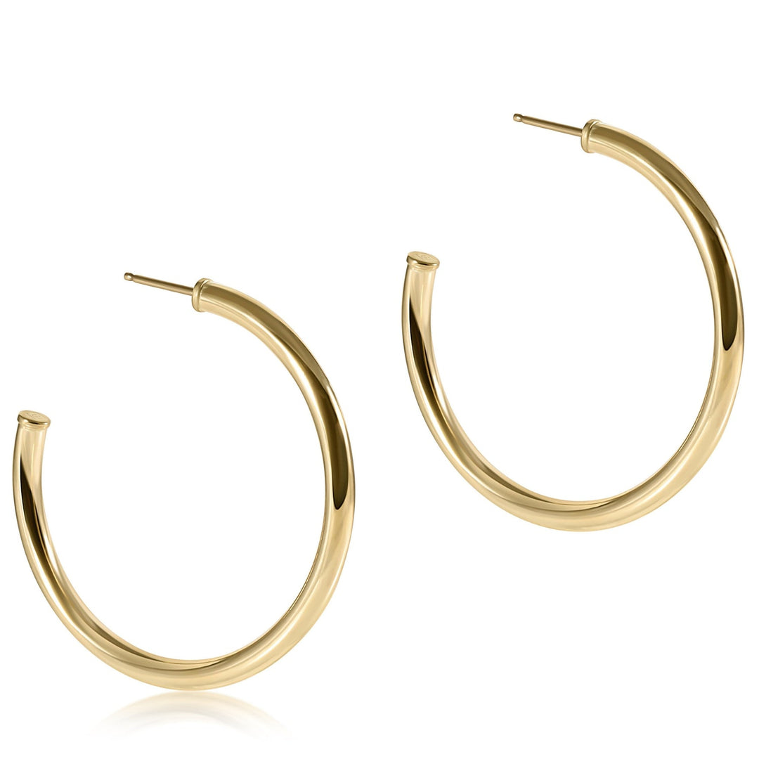 A pair of 1.5-inch round 14kt gold-filled smooth post hoop earrings with a 3mm thickness.