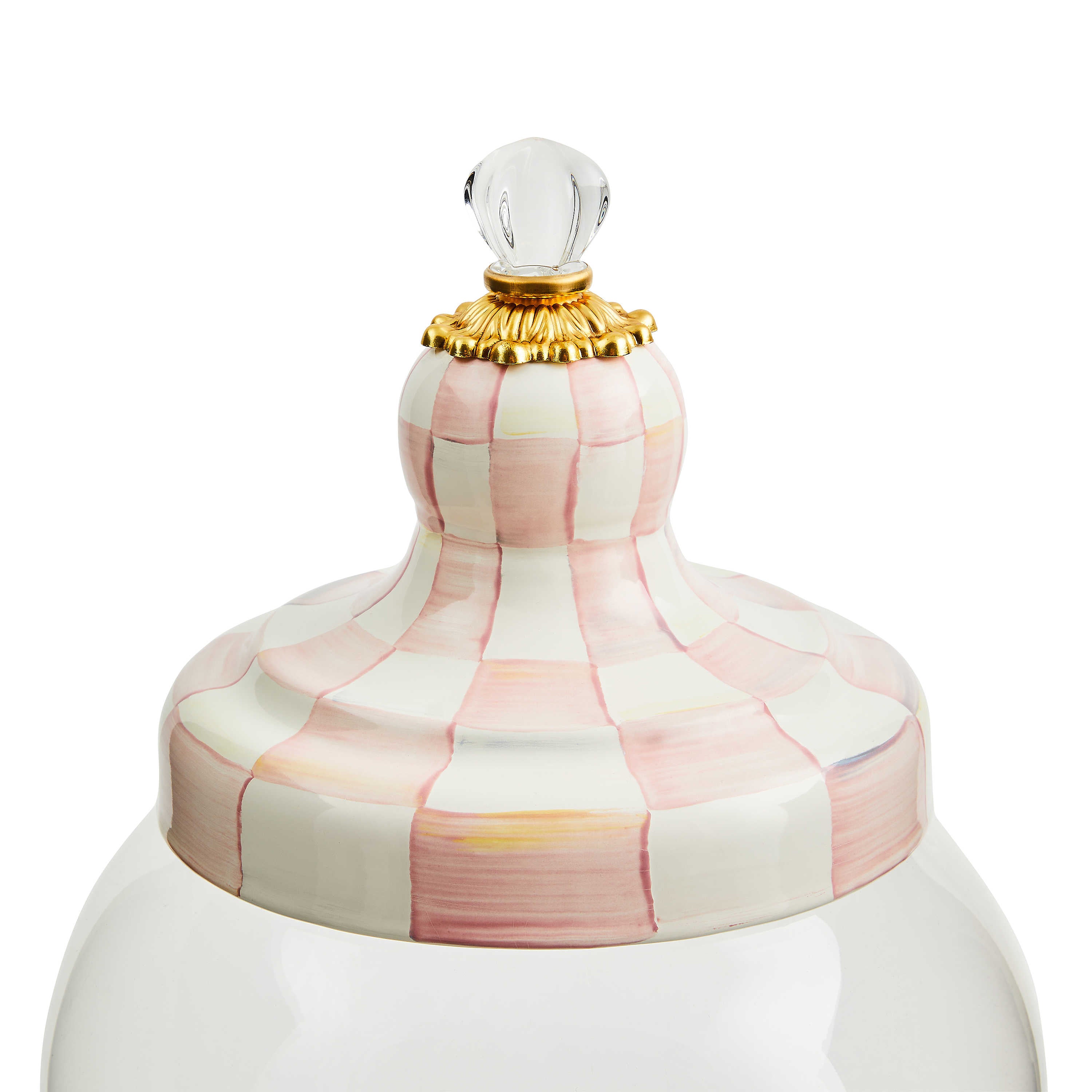 Close-up of a pink and white hand-painted checkered lid with a gold base and glass knob.