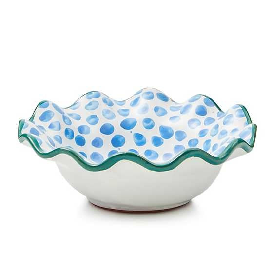 Hand-painted majolica ceramic berry bowl with green fluted rim, dot pattern on white background.
