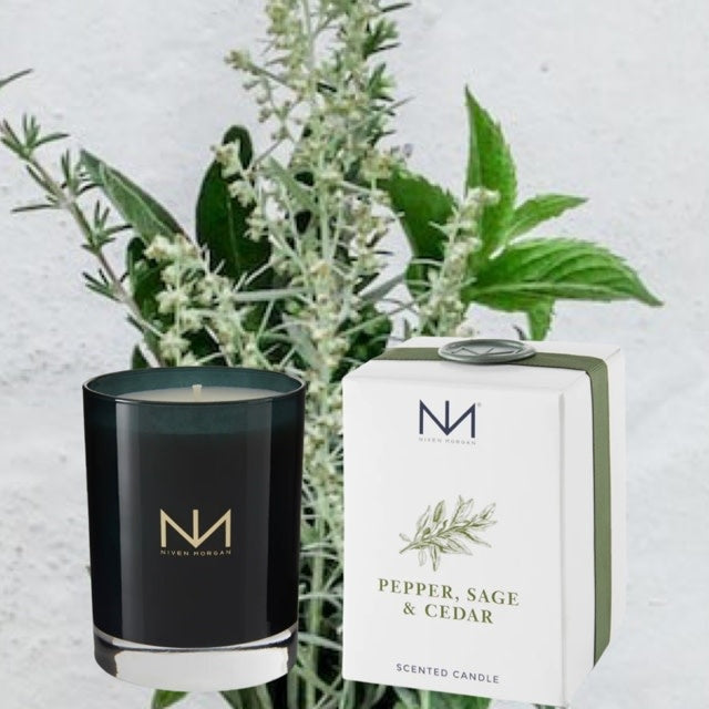 Dark navy glass candle with soy blend wax featuring pepper sage cedar fragrance
