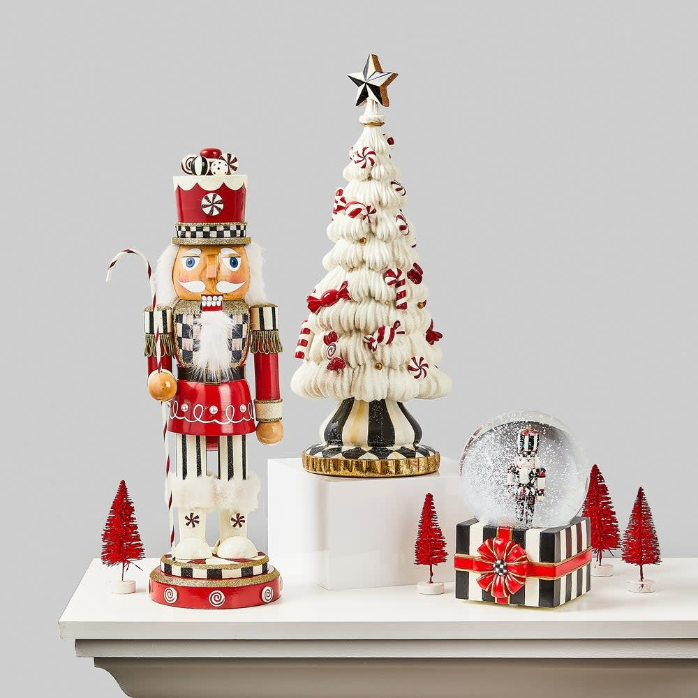Hand-painted wooden nutcracker in red Courtly Check fabric with peppermint candies and candy cane.