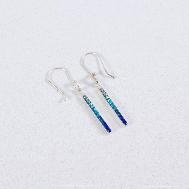 Petite blue stick earrings featuring sterling silver bessel settings filled with Austrian crystals in a geometric pattern.