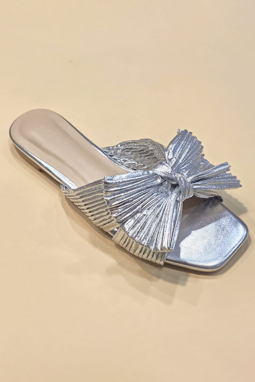 Metallic fabric ribbon slide flat sandals with a sleek silhouette.