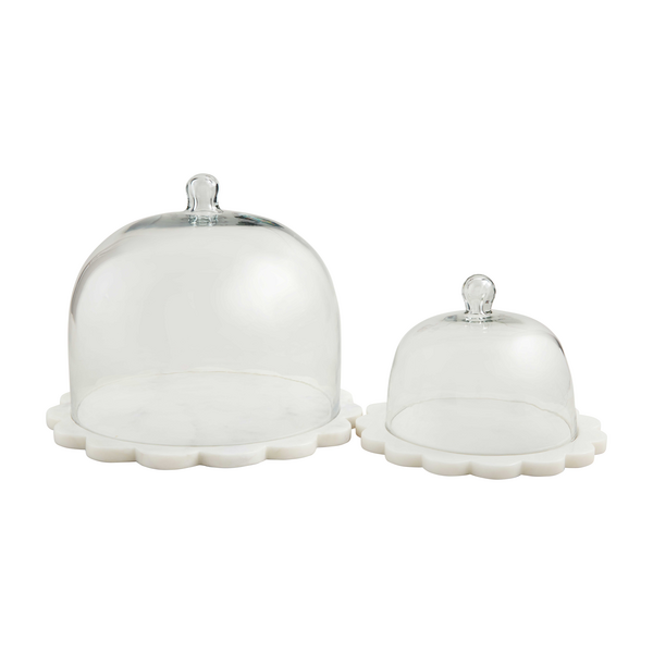 Scalloped marble cloche with a smooth white surface and decorative rim edge.