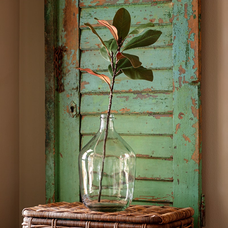 Artificial magnolia stem with green leaves on a 27-inch branch.