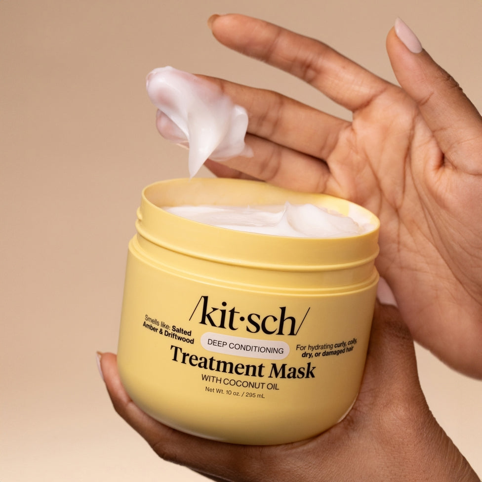 Moisturizing coconut oil deep conditioning treatment mask in a white bottle with black text.