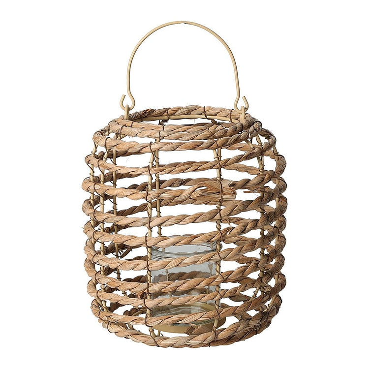 Hand-woven natural cattail leaf lantern with metal frame holding a candle inside.