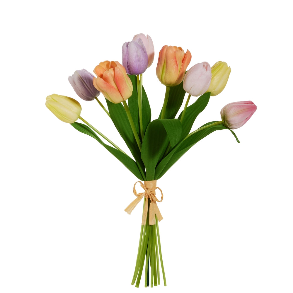 Bundle of four pastel pink tulips with realistic petals in a clear vase