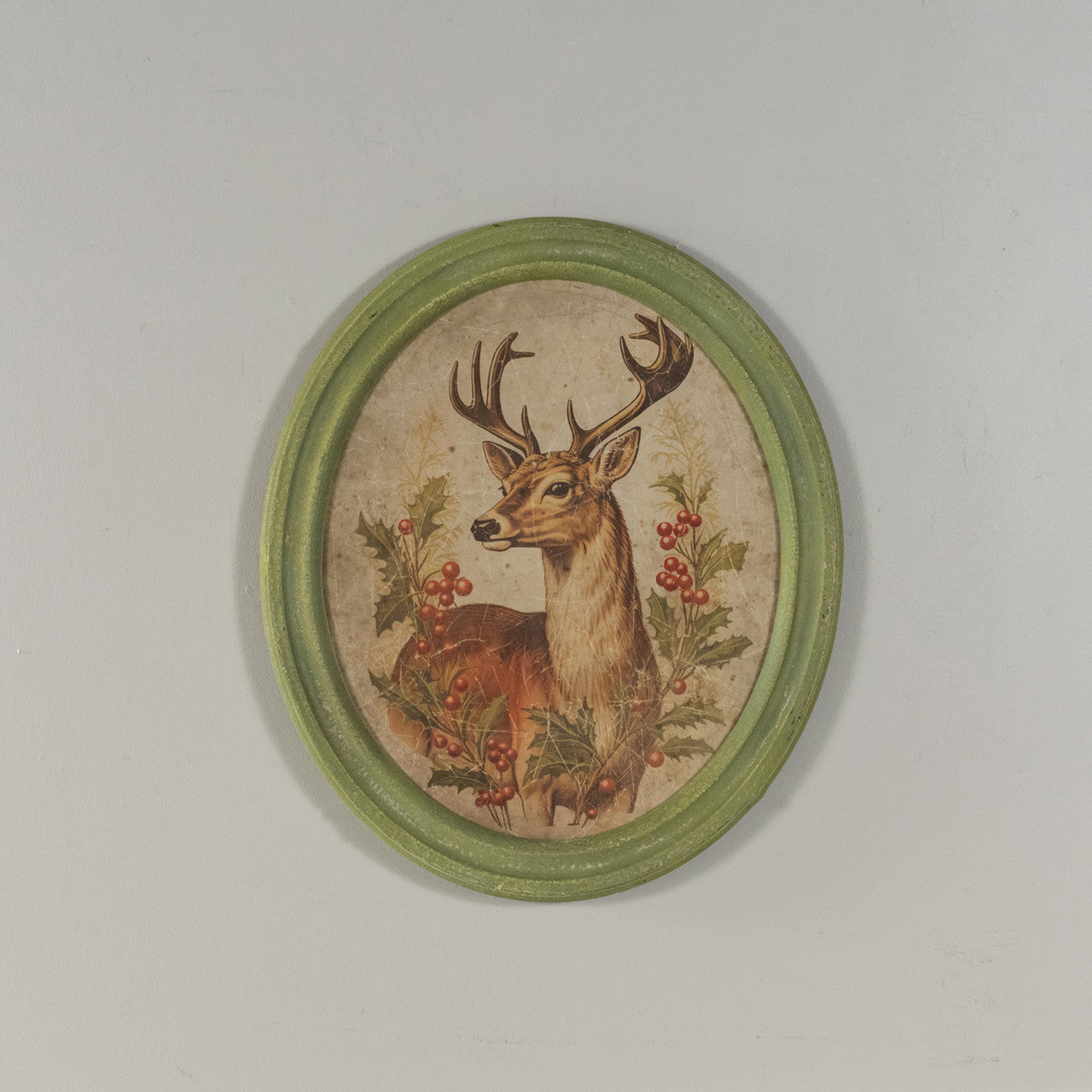 Oval framed print on glass featuring a holiday stag silhouette with natural wood frame.