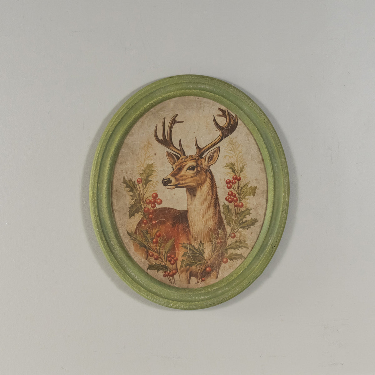 Oval framed print on glass featuring a holiday stag silhouette with natural wood frame.