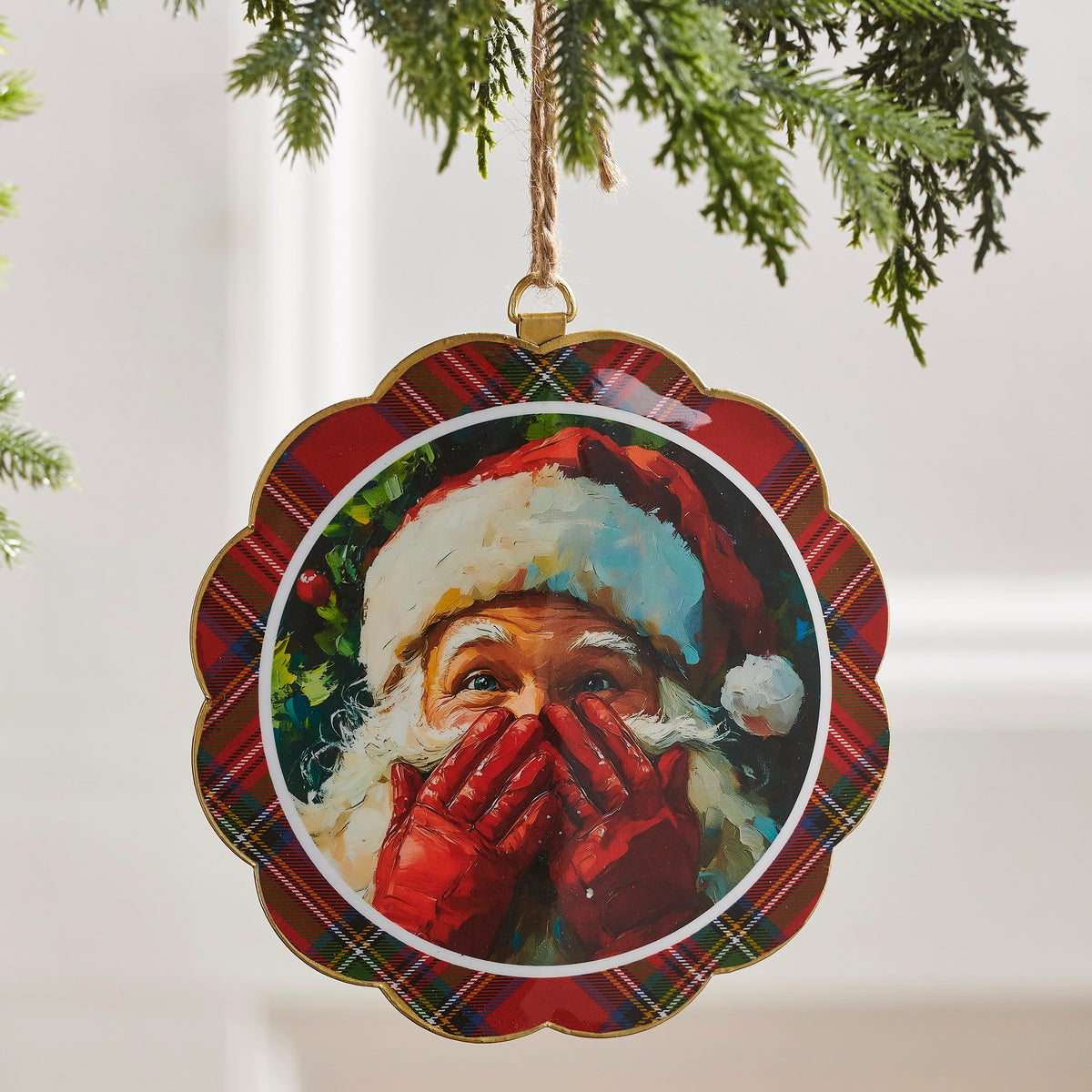 6-inch scalloped disc ornament featuring a painting of Santa Claus with a red plaid border.