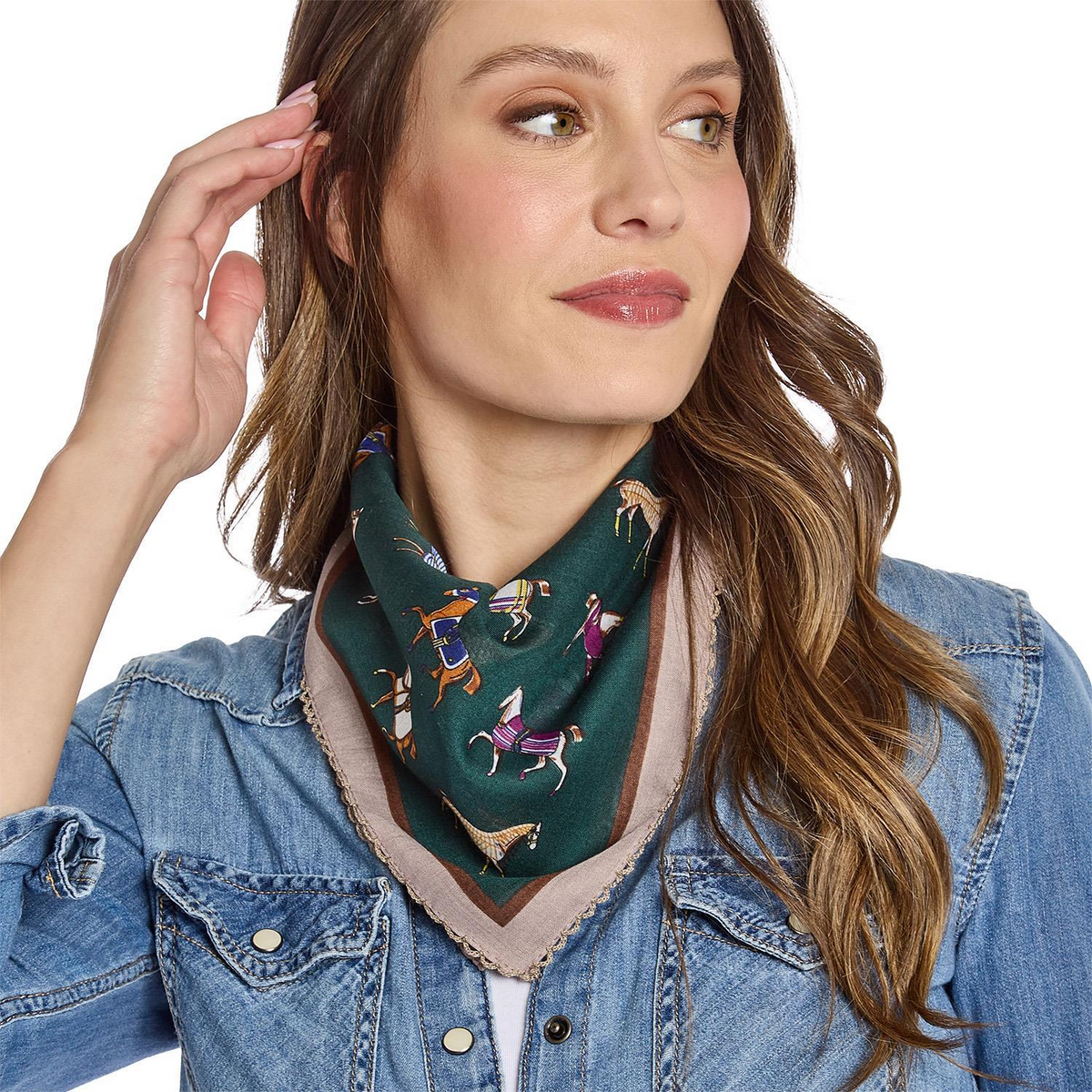 Woman wearing the Horse Play Soft Square Scarf in green with horse motifs and lace trim.