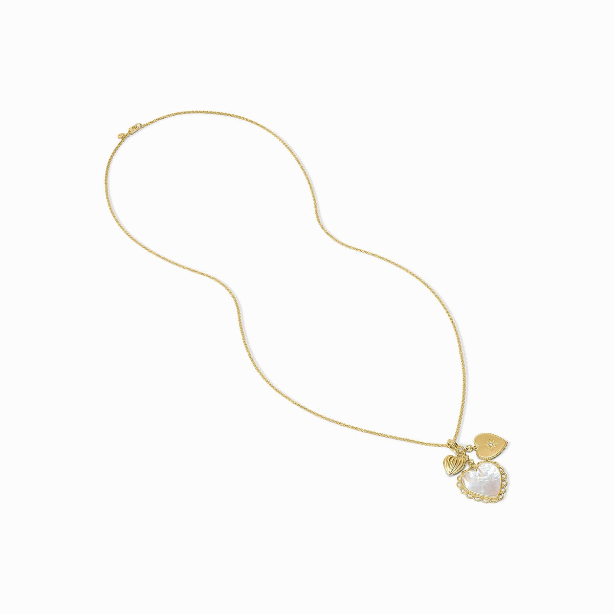 Gold chain necklace with three heart charms featuring mother of pearl and a starburst CZ detail.