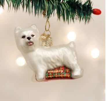 Glass Westie dog Christmas ornament hanging from a tree branch.