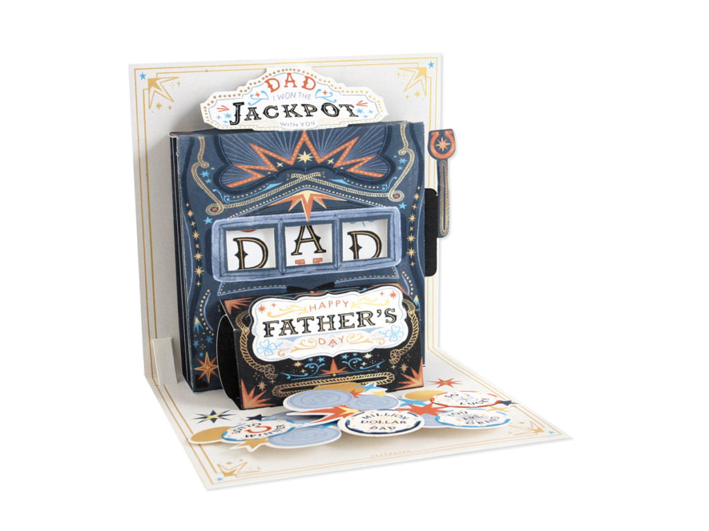 White envelope with gold foil text reading 'Dad Inside' and blue ink message about winning the jackpot.
