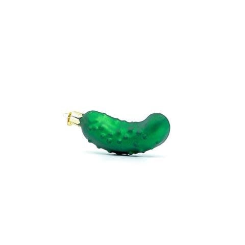 Green glass pickle ornament with gold stem hanging on a Christmas tree branch.