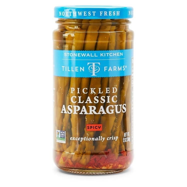 Jar of spicy pickled asparagus with green spears in brine