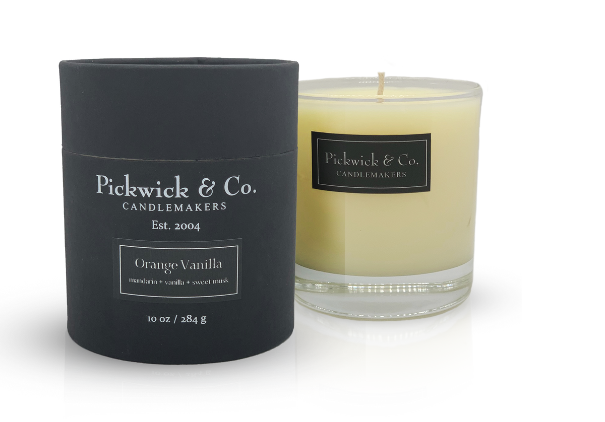 Pickwick Candle in orange vanilla scent with a white wax body.