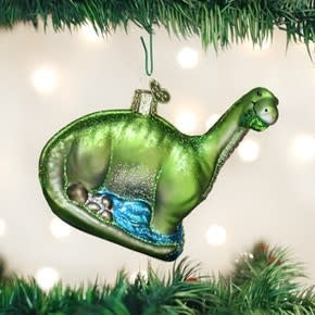 Brontosaurus ornament: a long-necked dinosaur figure in brown resin with textured skin and tail details.