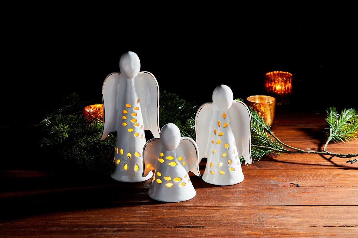Ceramic tea light lantern with cut-out detailing and electroplate metallic wing accents.