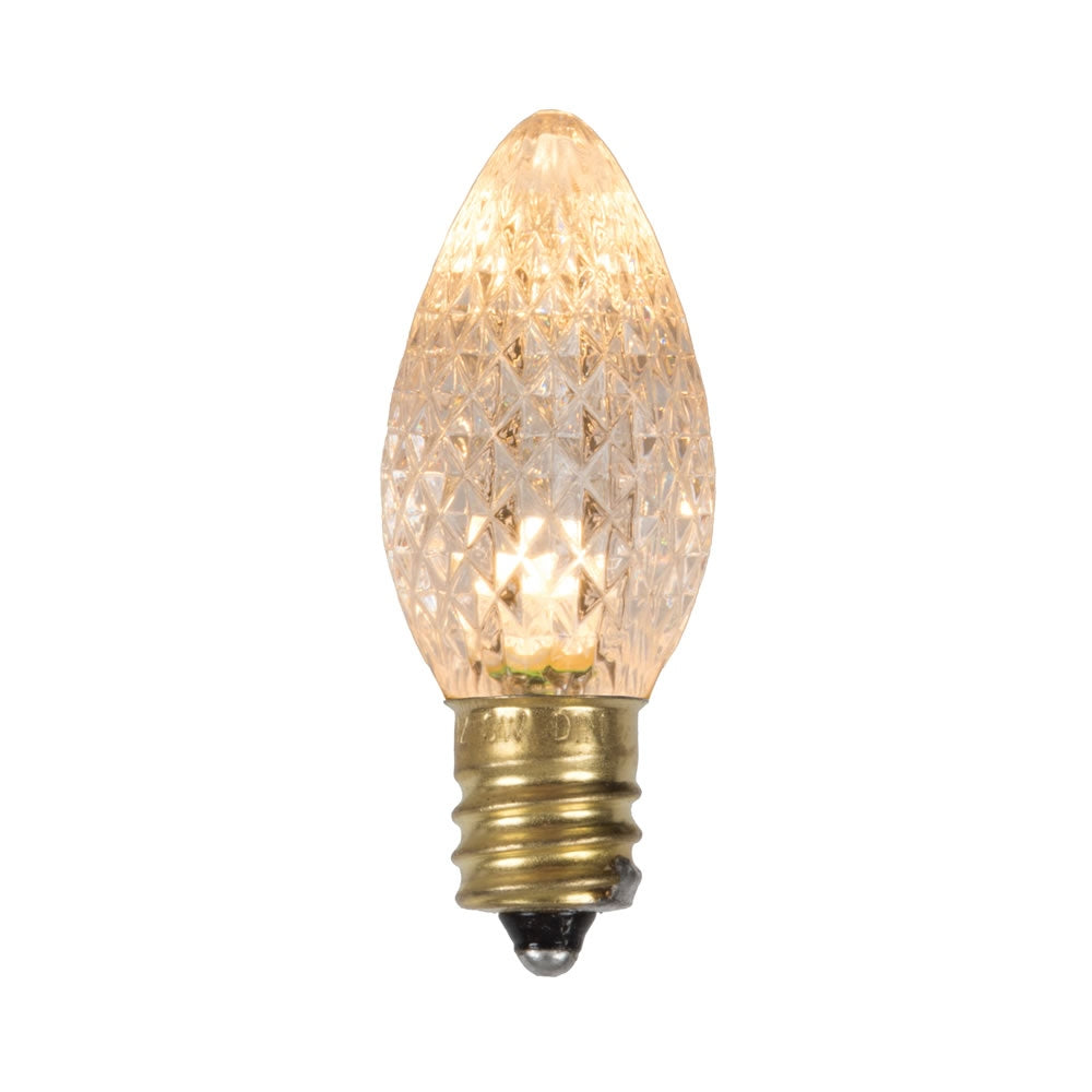 Single C7 faceted LED replacement bulb in sun warm white with a gold E12 base.