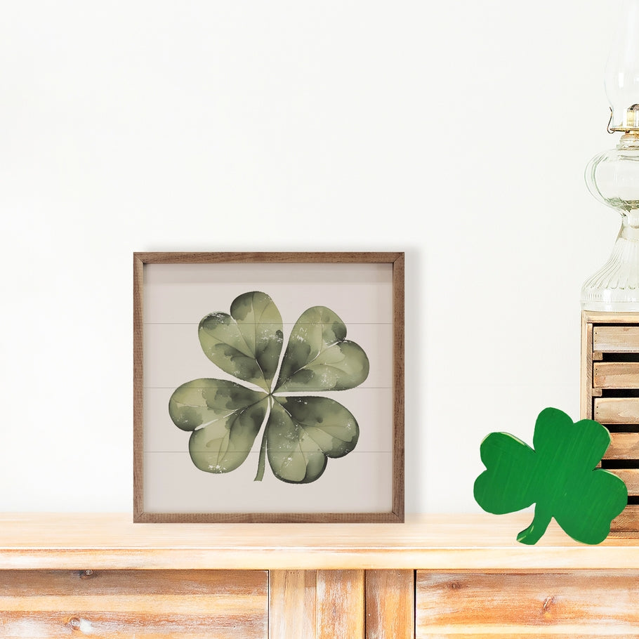 Hand-painted white four-leaf clover on American hardwood with natural walnut frame.