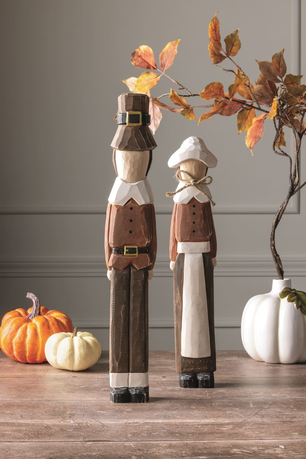 Hand-painted pine wood Pilgrim Sitter figurine with distressed chiseled texture and natural finish.