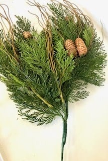 Artificial green cedar pine pick with brown pinecones and thin, wispy decorative twigs.