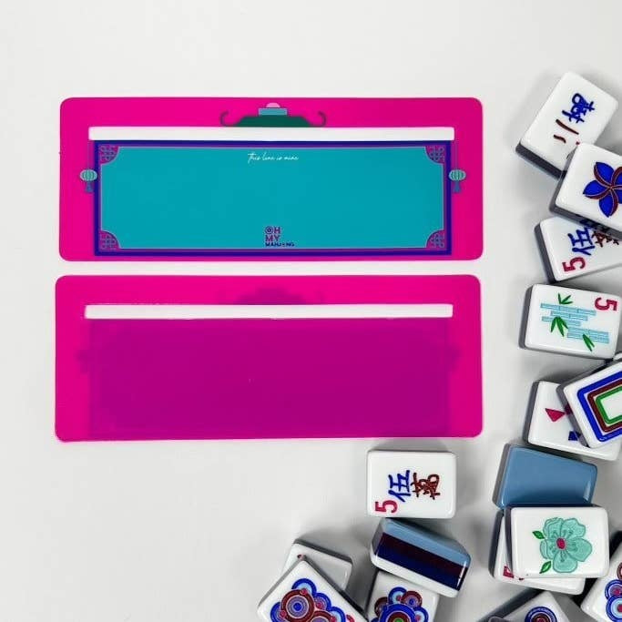 Pink plastic Mahjong line finder tool with a clear window to locate tile lines.