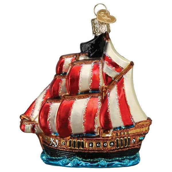 Glass pirate ship ornament with full sails, Jolly Roger flag, silver accents, and hand-applied glitter.