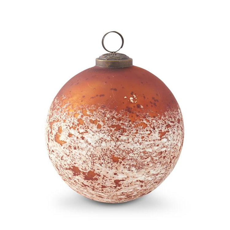 5-inch dark orange glass ornament with a white speckled finish and brass hanging loop.