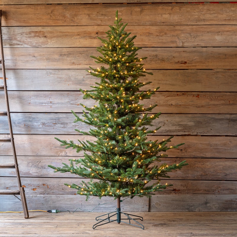 7.5-foot Grand Noble artificial Christmas tree with warm white lights and a metal stand.