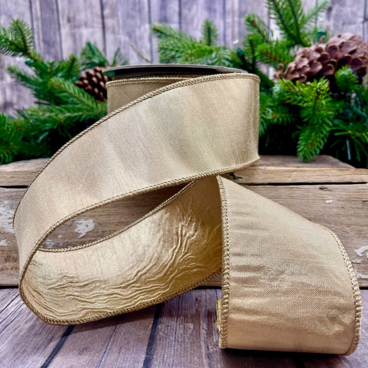 A roll of gold metallic dupion fabric measuring 2.5 inches wide by 10 yards long.