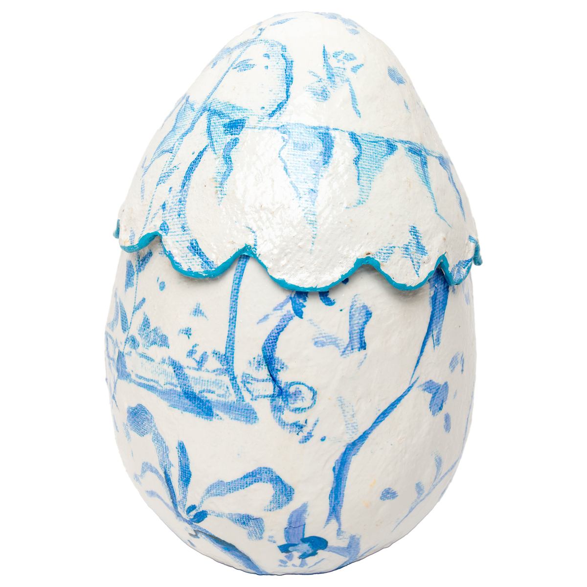 Blue scallop-shaped egg planter with chinoiserie floral patterns on a white ceramic surface.