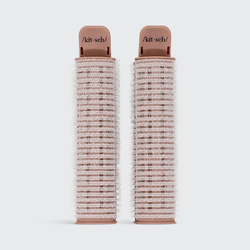 Two rose gold Volumizing Roller Clips with velcro texture and Kitsch branding.