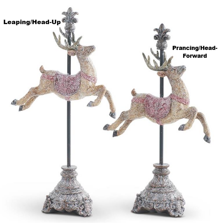 Two glittered resin reindeer figurines on finial stands, one leaping and one prancing.