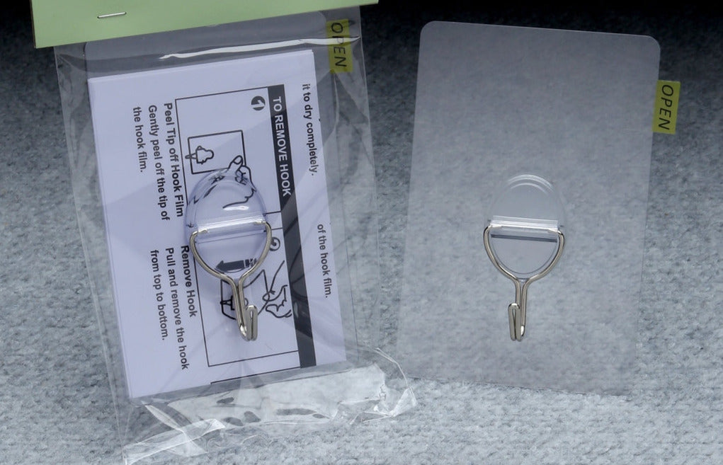 Magic Self Adhesive Wreath Hanger with clear backing and metal hook, shown with instructions.