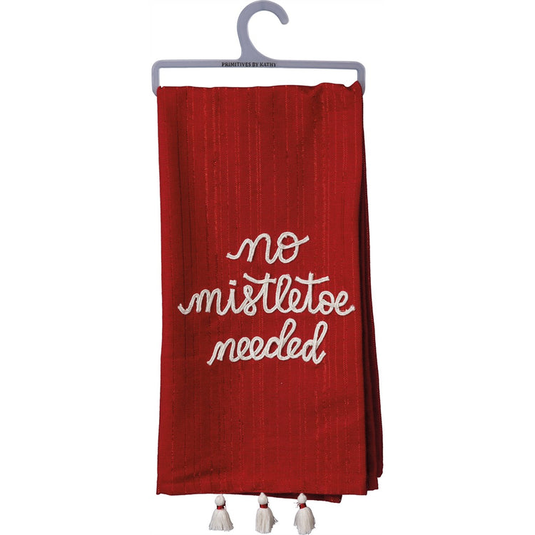 Red striped dish towel with white embroidered text 'no mistletoe needed' and white tassels.
