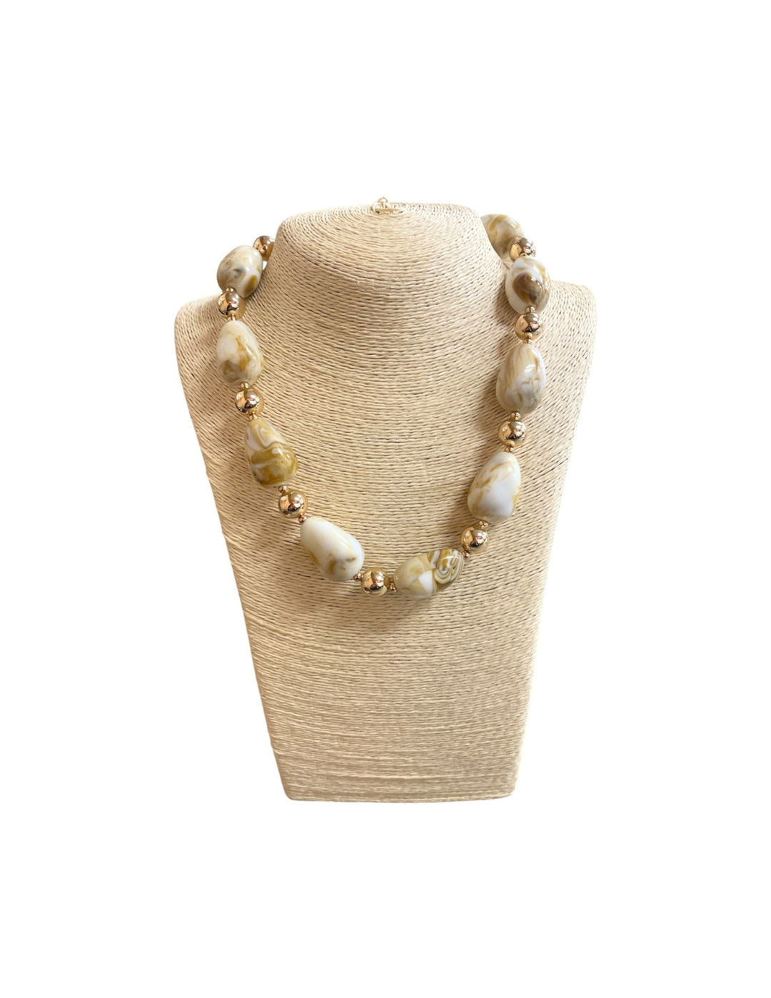 Acrylic pebble multi-beaded necklace with marbled cream and tan stones and gold spacers.