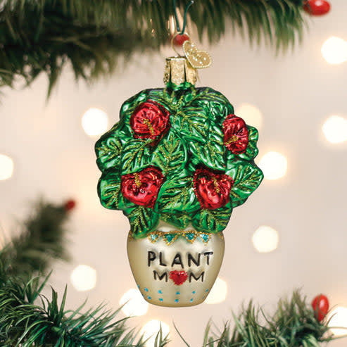 Red ceramic Christmas ornament shaped like a potted succulent plant with green leaves.