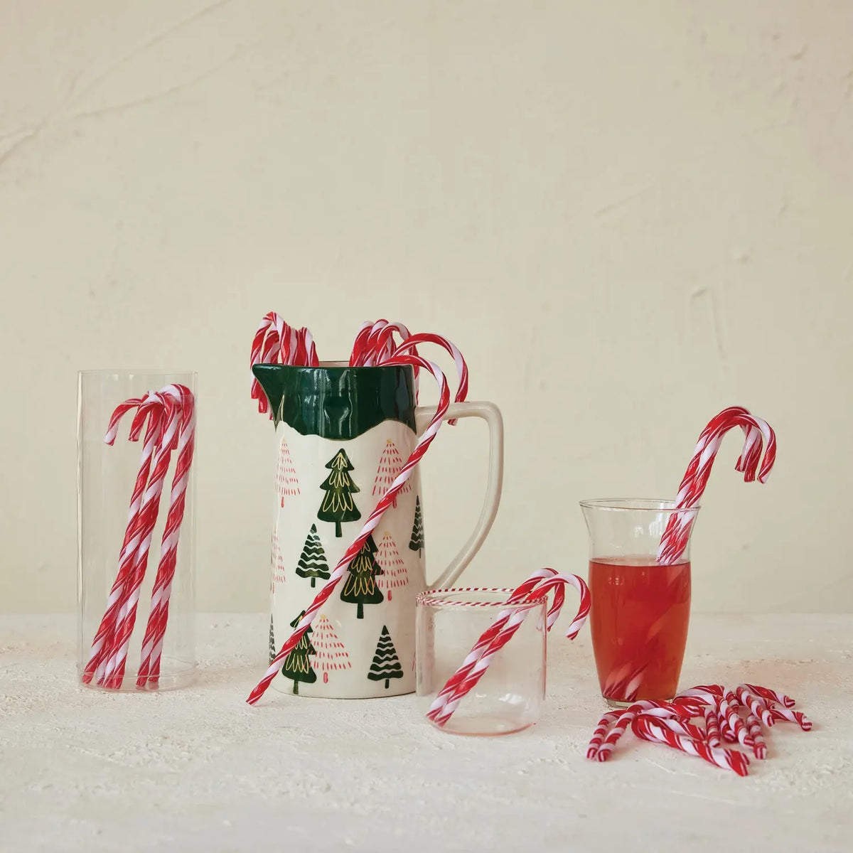 Set of plastic drink stirrers shaped like red-and-white striped candy canes.