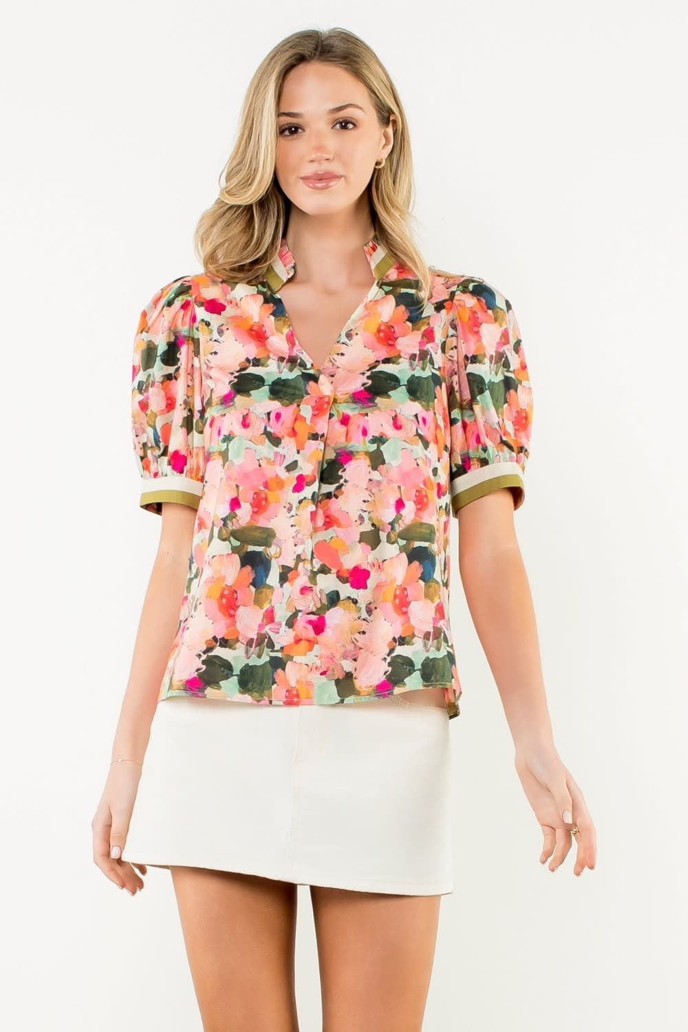 Front view of a white woven cotton top with pleated collar and puff sleeves.