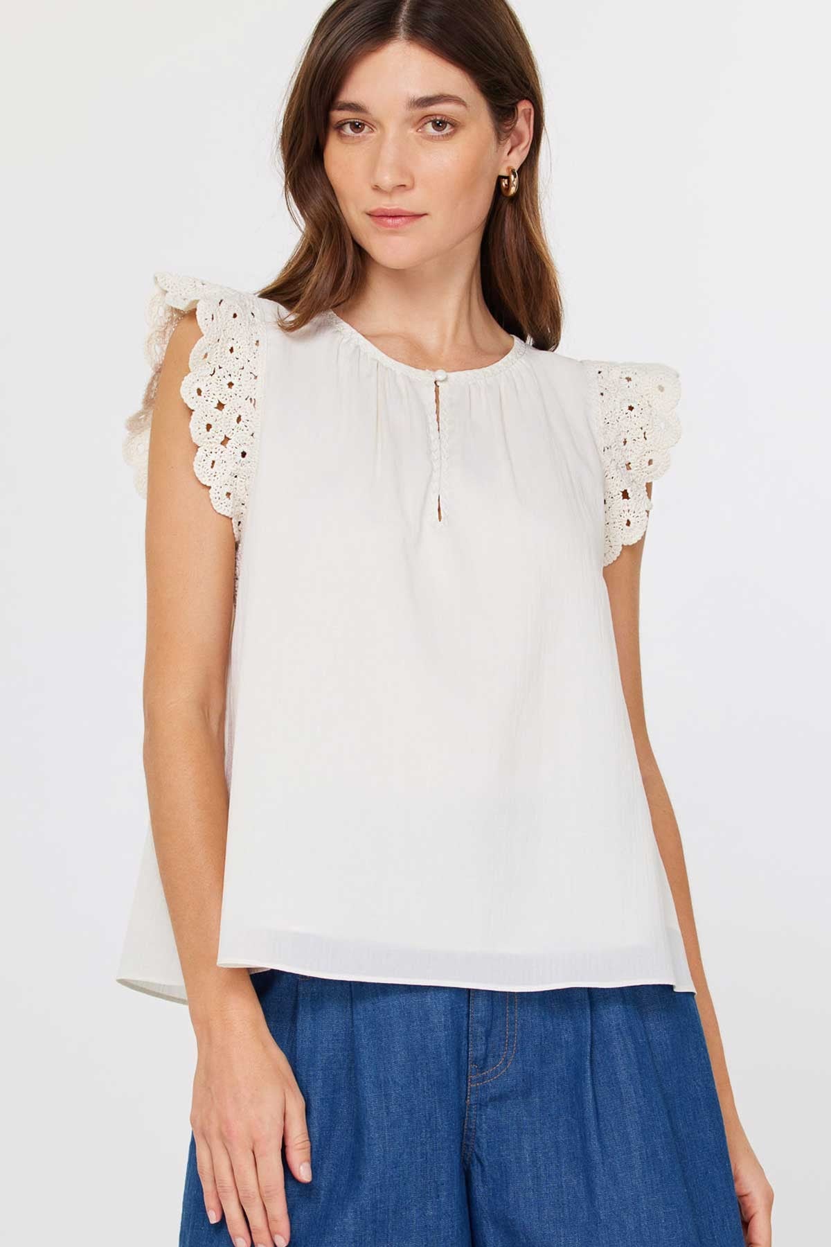 Women's Annie crochet blouse in light blue with short sleeves, round neck, front buttons, and keyhole back detail.