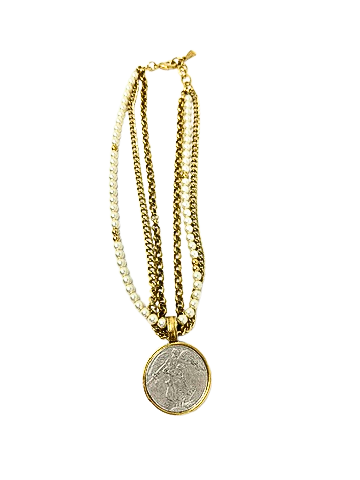 Layered gold chain and pearl necklace featuring a large silver angel medallion pendant.