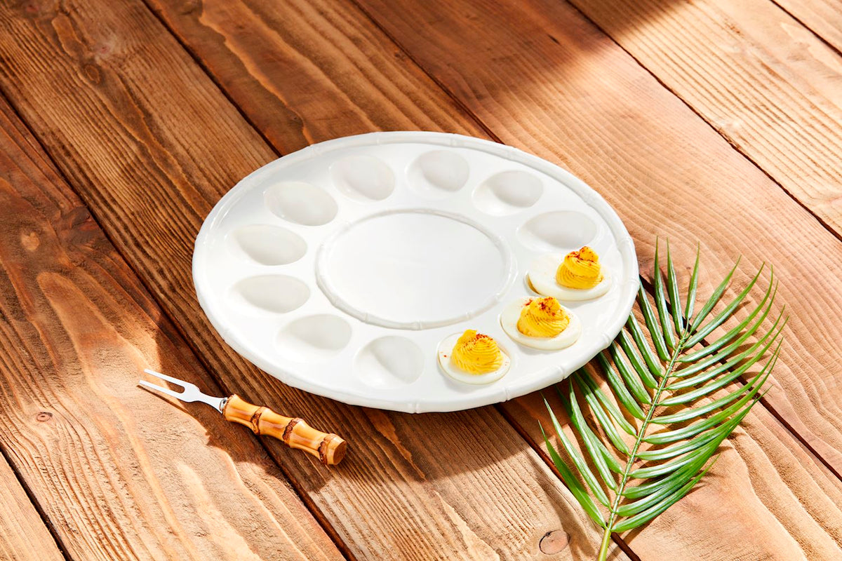 White stoneware deviled egg tray set with a circular shape.