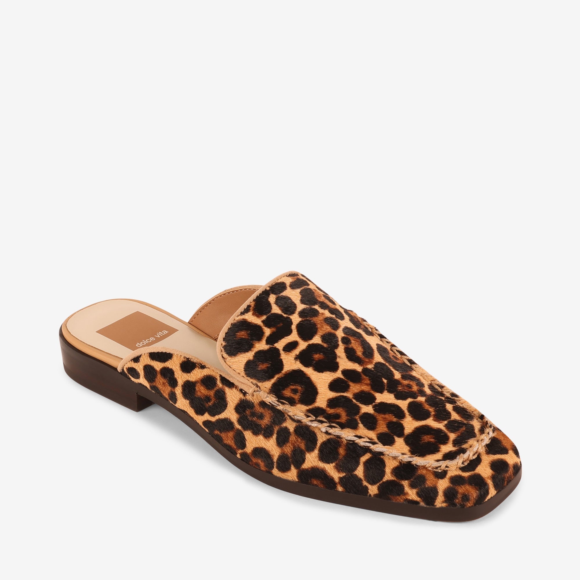Bradly slip-on mule with cow print calf hair upper, recycled synthetic outsole, and water-based leather alternative lining.
