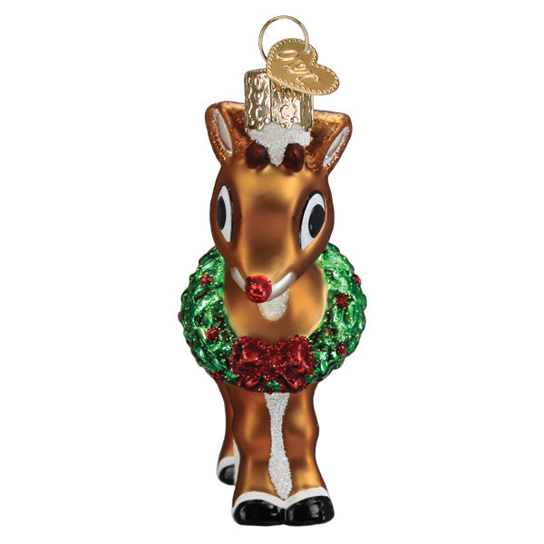 Rudolph the Red-Nosed Reindeer glass ornament wearing a green wreath with a red bow.