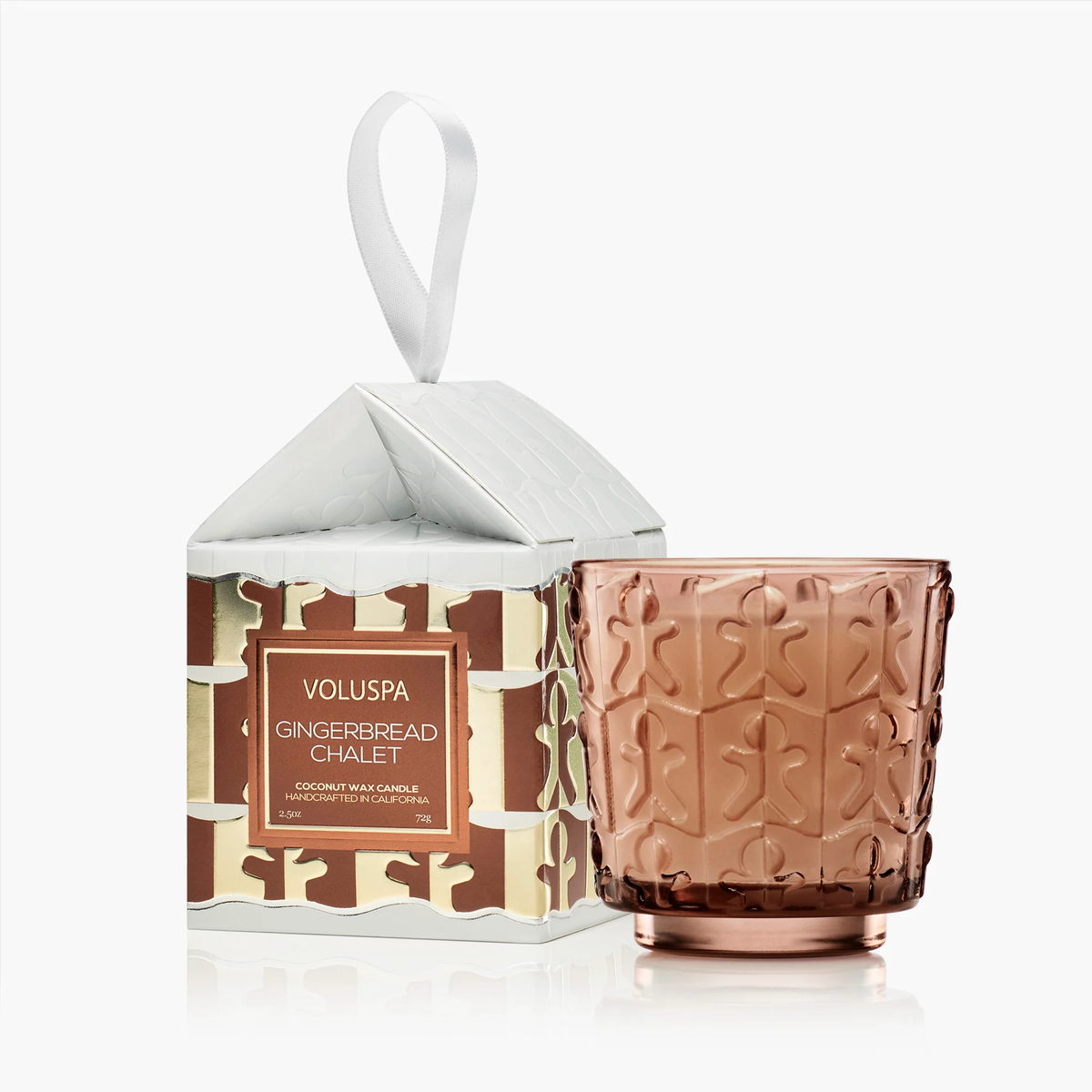 Voluspa Gingerbread Chalet 2.5oz candle in a brown glass jar next to its house-shaped ornament box.