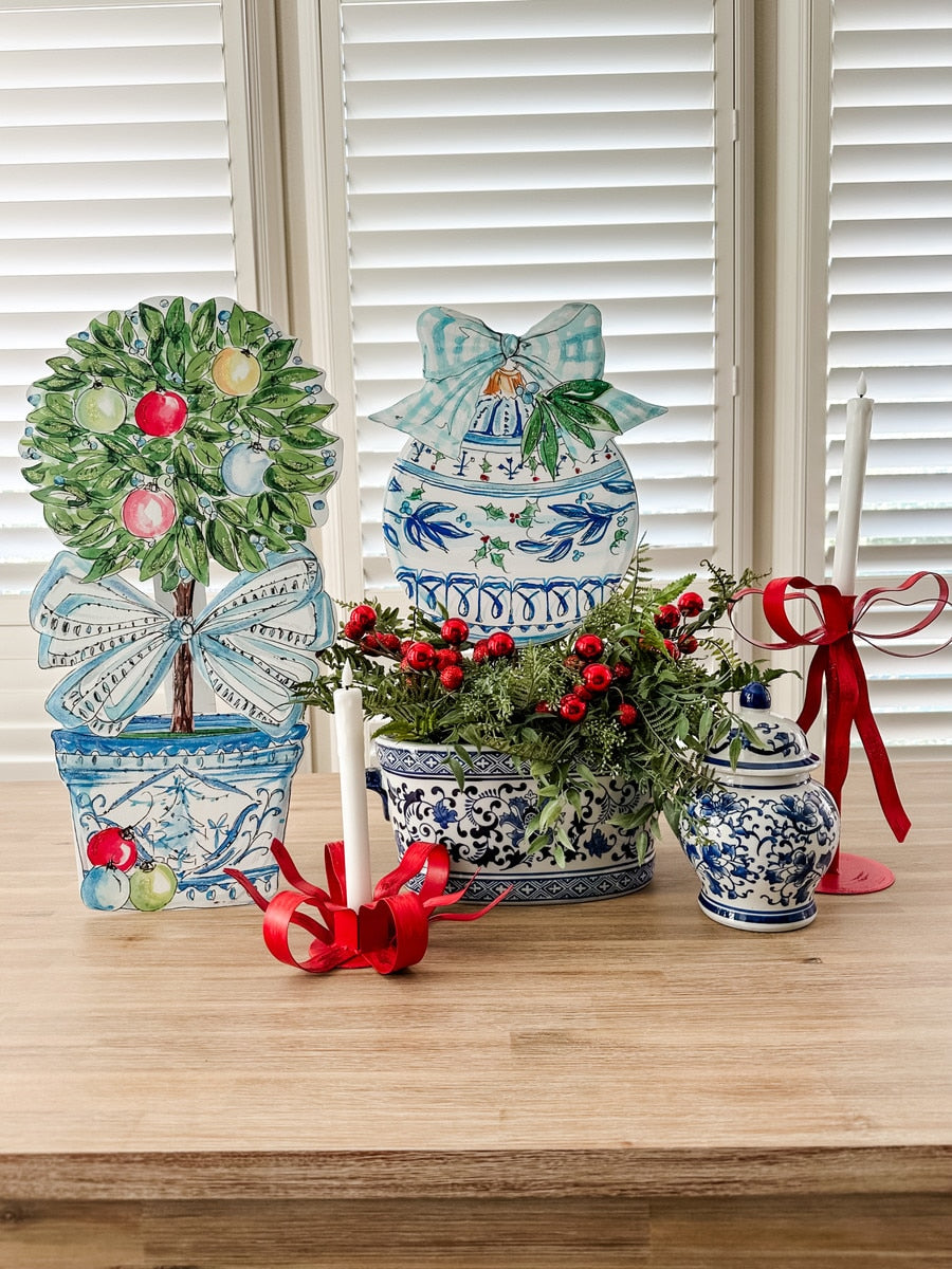 Beck's Winter Wonderland topiary stake featuring a white frosted pine tree silhouette with red berry accents.